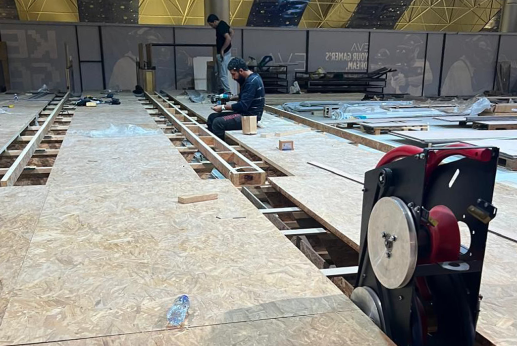 Indoor bowling lanes being built with professional tools and materials.