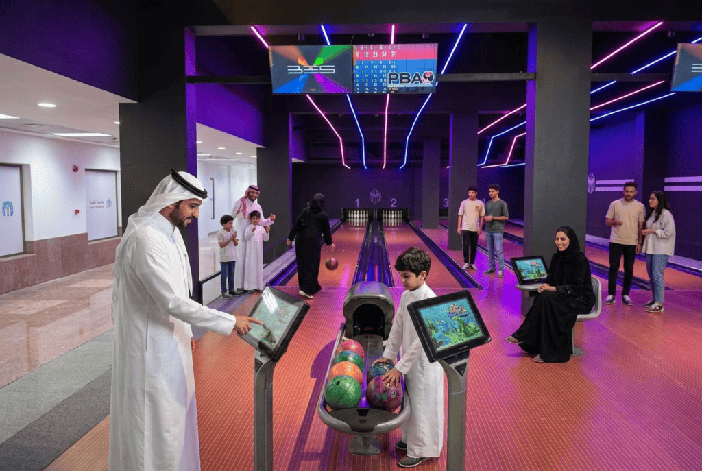 Bowling alley at Thebes University with students playing and having fun.